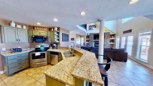 a kitchen and living room with a counter top at Moab Desert Home, 4 Bedroom Private House, Sleeps 10, Pet Friendly in Moab