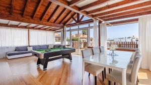 a living room with a pool table and a couch at Luxury Villa Nieve in Caleta De Fuste