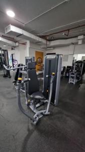 a gym with several rows of tread machines at Nice Studio Near The Sea in Ras al Khaimah