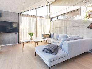 a living room with a couch and a table at 8 person holiday home in Hirtshals-By Traum in Hirtshals