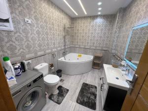 a bathroom with a washing machine and a sink at Pyramids View Apartment in Giza