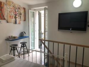 a living room with a flat screen tv on the wall at Rio Rest Apartments in Riomaggiore