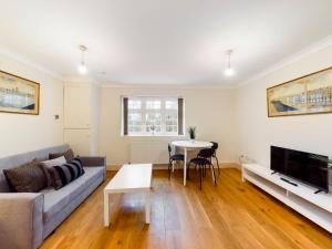 a living room with a couch and a table at Redhill town centre apartments by Livingo in Redhill