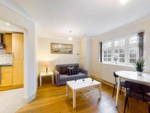 a living room with a couch and a table at Redhill town centre apartments by Livingo in Redhill