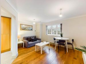 a living room with a couch and a table at Redhill town centre apartments by Livingo in Redhill +11 photos
