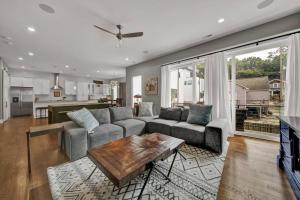 a living room with a couch and a table at City Views RoofTop Hot Tub & Short Walk to Stadium in Charlotte
