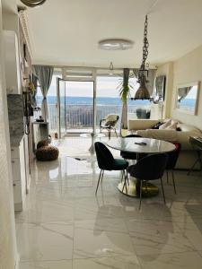 a large living room with a table and chairs at SUITE-XXI City View Hotelturm Augsburg in Augsburg