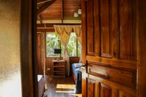 a room with a wooden door and a window at Casa Drake Lodge in Drake