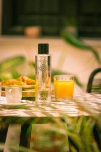 a bottle of orange juice sitting on top of a table at Madeinterranea Suites in Málaga