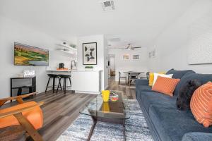 a living room with a blue couch and a table at The 1 at Biarritz-Remodeled 1 br in Downtown PS in Palm Springs