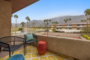 a balcony with two chairs and a table and chairs at The 1 at Biarritz-Remodeled 1 br in Downtown PS in Palm Springs