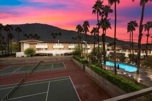 a building with two tennis courts and palm trees at The 1 at Biarritz-Remodeled 1 br in Downtown PS in Palm Springs