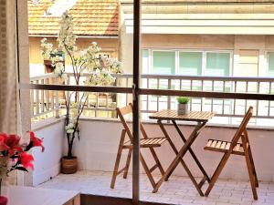 a balcony with a table and two chairs at Chabós Plaza España - Charming Flats in Vigo