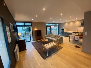 a living room with a couch and a table at Parc Beausejour Aparthotel in Dieppe