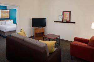 a hotel room with a couch and a bed and a tv at Residence Inn Shelton Fairfield County in Shelton