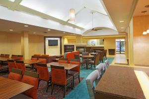 a dining room with wooden tables and chairs at Residence Inn by Marriott Austin Parmer/Tech Ridge in Austin