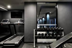 a gym with a view of a city at Midnight Hotel, Autograph Collection in Canberra