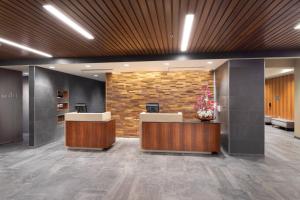 a lobby with two reception desks and a brick wall at Courtyard by Marriott Bowie in Bowie