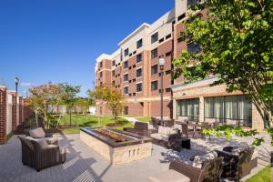 a patio with a fire pit in front of a building at Courtyard by Marriott Bowie in Bowie