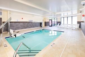 a swimming pool with blue water in a building at Courtyard by Marriott Bowie in Bowie