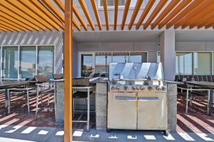a grill on a patio with tables and chairs at TownePlace Suites by Marriott El Paso East/I-10 in El Paso