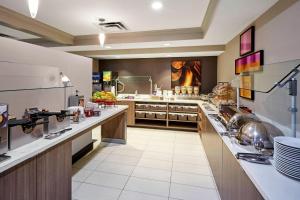 a large kitchen with a long counter in a restaurant at Residence Inn by Marriott Chicago Schaumburg/Woodfield Mall in Schaumburg