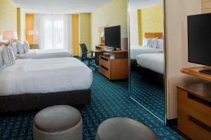 a hotel room with two beds and a mirror at Fairfield Inn & Suites by Marriott Bridgewater Branchburg/Somerville in Branchburg Park