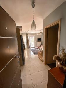 a kitchen with a open door to a living room at Luxury Equiped Apartment - Olympic Beach in Olympiaki Akti