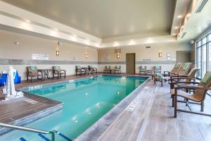 a pool with chairs and tables in a hotel room at Fairfield Inn & Suites by Marriott Cheyenne Southwest/Downtown Area in Cheyenne