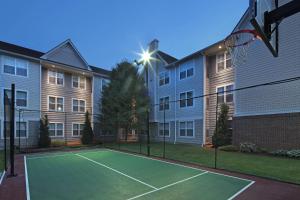 a tennis court in front of a apartment building at Residence Inn Southington in Southington