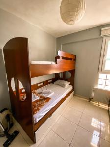 a bedroom with two bunk beds in a room at Luxury Equiped Apartment - Olympic Beach in Olympiaki Akti