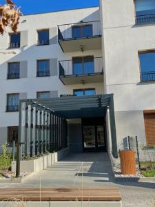 a building with a hallway leading to a building at Apartment Olive in Białołęka-Tarchomin Center in Warsaw