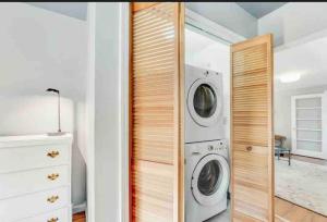 a laundry room with a washer and dryer at River Front Home In the Heart of Ithaca in Ithaca