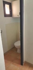 a bathroom with a toilet and a window at maison de village rogliano / macinaggio cap corse in Rogliano