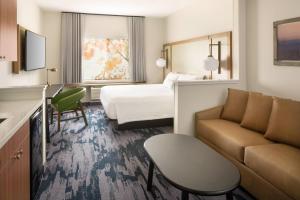 a hotel room with a bed and a couch at Fairfield Inn and Suites by Marriott Napa American Canyon in Napa