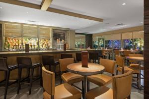 a restaurant with a bar with chairs and tables at Boulder Marriott in Boulder