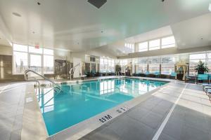 a large swimming pool with blue water in a building at Residence Inn by Marriott Philadelphia Glen Mills/Concordville in Glen Mills