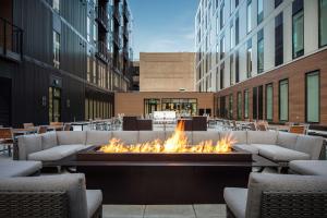 a fire pit in the middle of a city with buildings at Element Iowa City in Iowa City