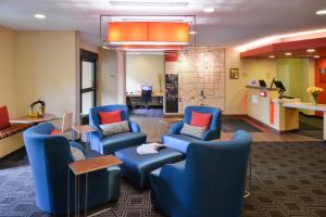 a waiting room with blue chairs and a table at TownePlace Suites by Marriott Las Vegas Henderson in Las Vegas