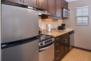 a kitchen with a refrigerator and a stove at TownePlace Suites by Marriott Las Vegas Henderson in Las Vegas