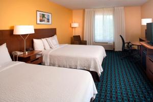 a hotel room with two beds and a television at Fairfield Inn by Marriott Denver / Westminster in Westminster