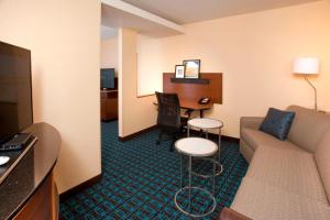 a hotel room with a couch and a table at Fairfield Inn by Marriott Denver / Westminster in Westminster