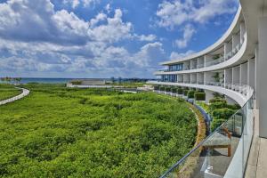 an exterior view of a building with a green lawn at The St. Regis Kanai Resort, Riviera Maya in Playa del Carmen