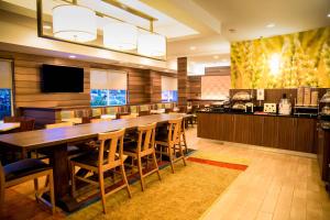 a large dining room with a long table and chairs at Fairfield Inn & Suites Fredericksburg in Fredericksburg