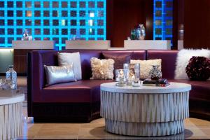 a purple couch and a table in a room at Renaissance Las Vegas Hotel in Las Vegas