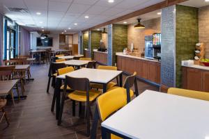 a dining room with tables and yellow chairs at Fairfield Inn and Suites by Marriott Bakersfield Central in Bakersfield