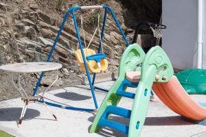 a playground with a slide and a swing at Cottage Eco-Friendly Barcelona country side in La Garriga