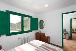 a bedroom with green shuttered windows and a bed at Cottage Eco-Friendly Barcelona country side in La Garriga +40 photos