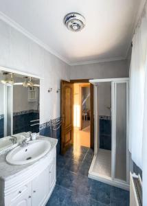 a white bathroom with a sink and a shower at Villa de Melle – Seaview – beach 5 min by foot in Ferrol