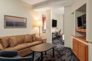 a living room with a couch and a table at Fairfield Inn & Suites San Angelo in San Angelo